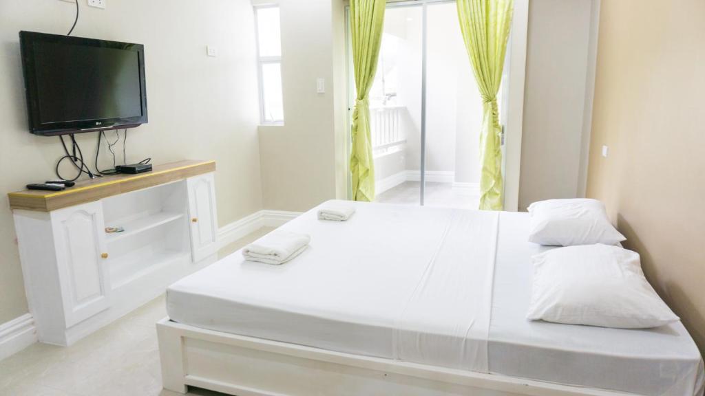 Postel nebo postele na pokoji v ubytování Sandscape Hotel