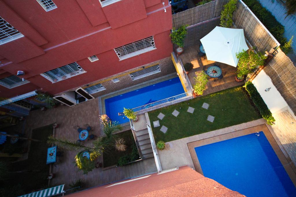 einen Blick über zwei Pools vor einem Gebäude in der Unterkunft Riad Mimosa in Fès