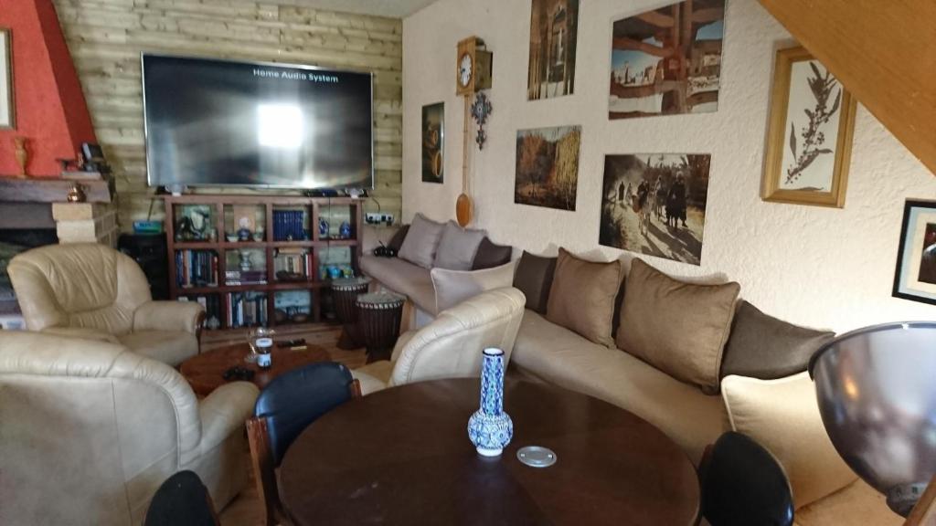 a living room with a couch and a table at La Ferme Oasis in Belloy