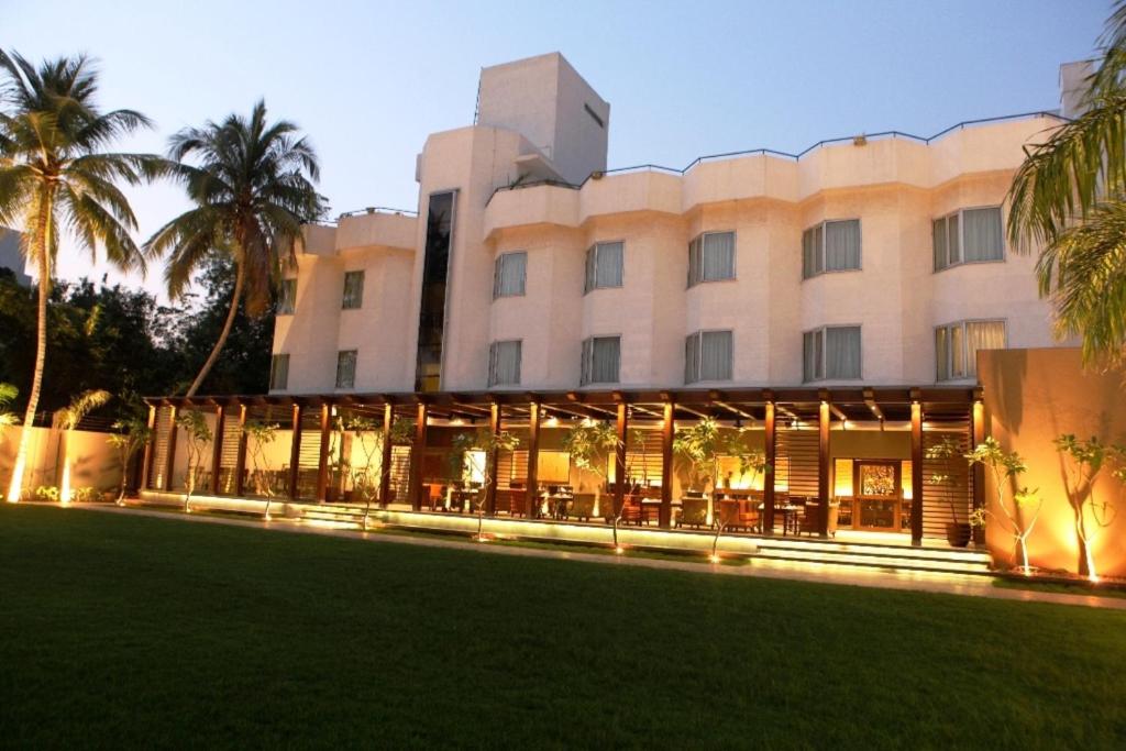 a building with a lawn in front of it at Hotel Express Residency Vadodara in Vadodara