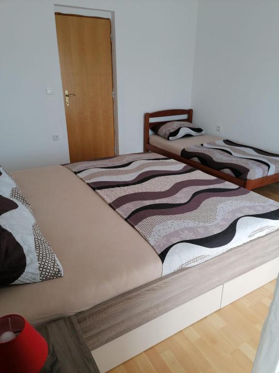 Posteľ alebo postele v izbe v ubytovaní Apartment Niva