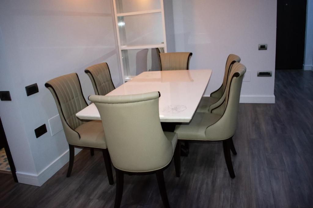 una mesa blanca y sillas en una habitación en apartament valcea en Râmnicu Vâlcea