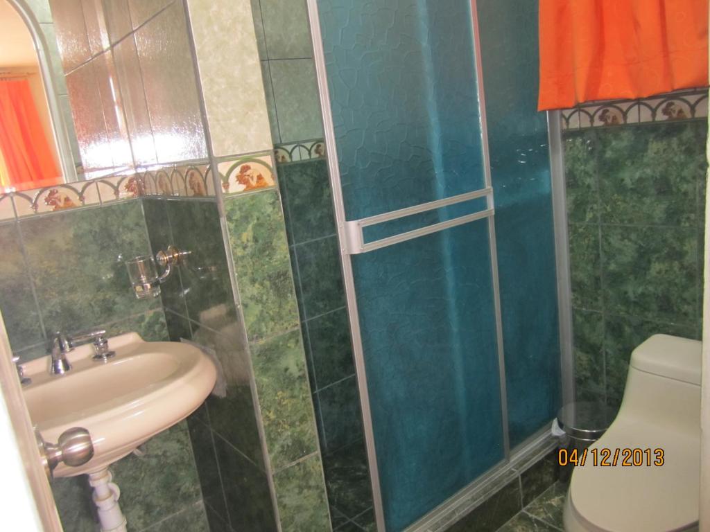 a bathroom with a shower, sink, and toilet at Bed & Breakfast Cleofe Arequipa in Arequipa