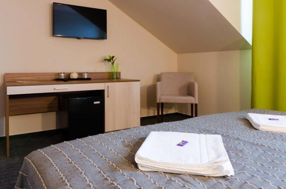 A bed or beds in a room at Penzion Lipa