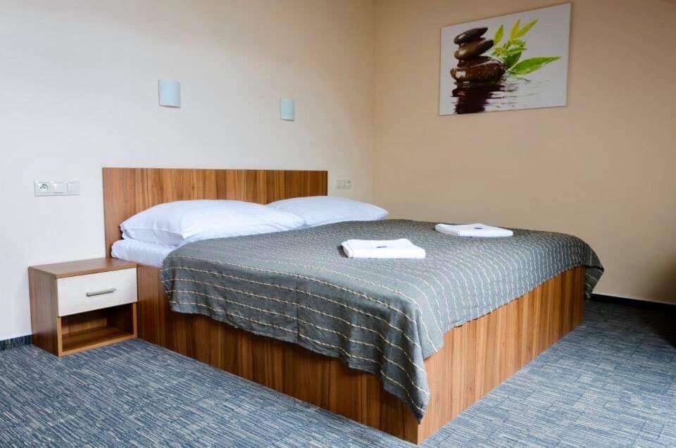 A bed or beds in a room at Penzion Lipa