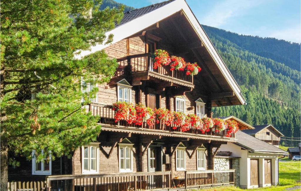 a house with flower boxes on the balcony of it at 1 Bedroom Awesome Home In Sankt Veit-defereggenta in Gassen