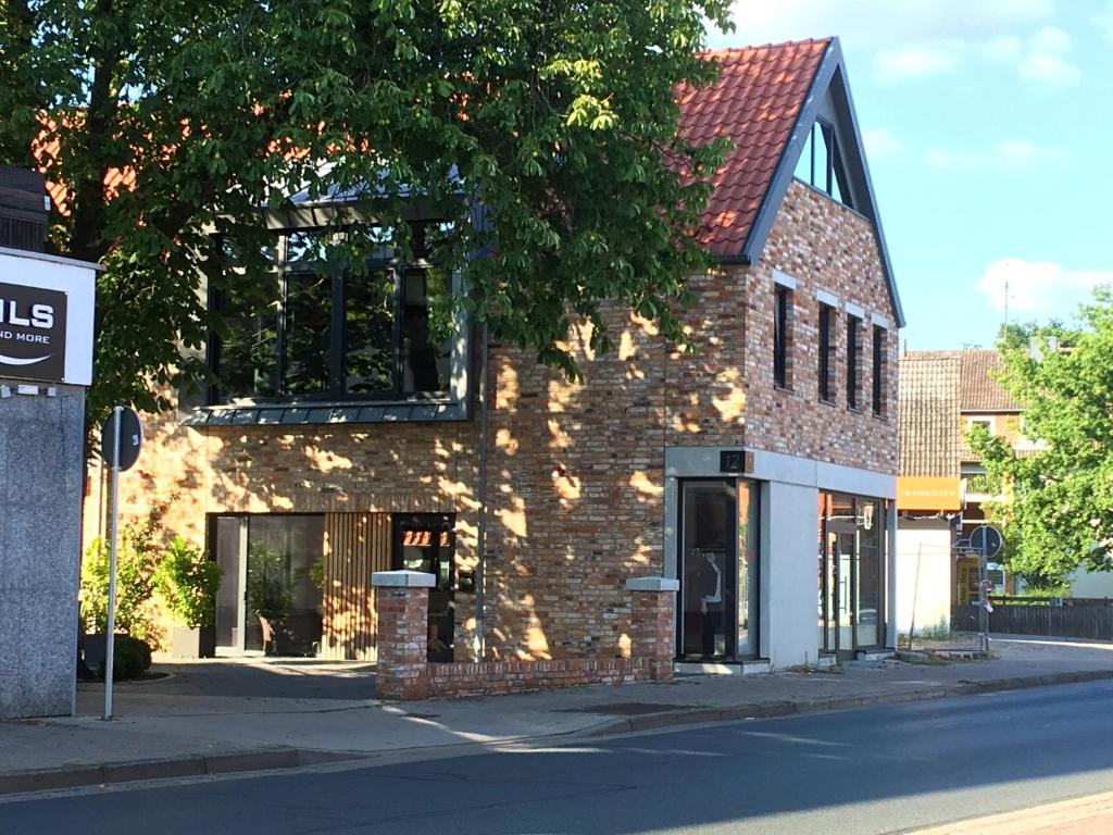 a brick building on the side of a street at The Townhouse Apartment in Burgwedel
