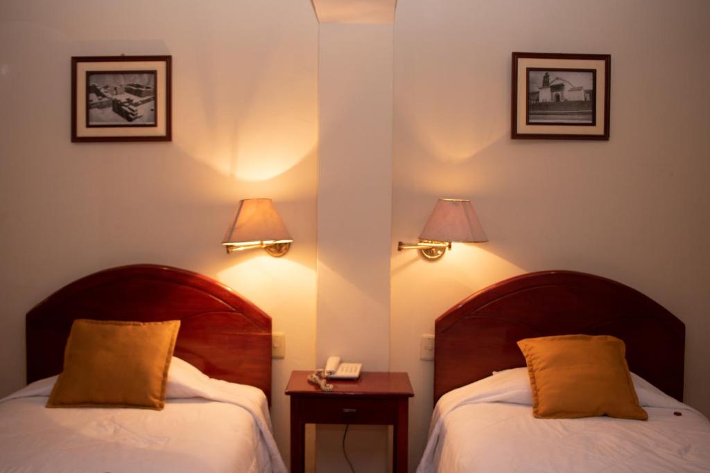 Postel nebo postele na pokoji v ubytování Hotel Vilandre