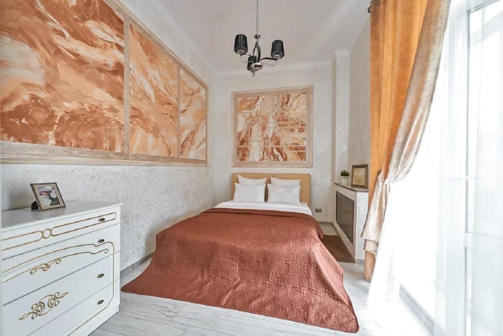 a bedroom with a bed and a painting on the wall at PaulMarie Apartments on Prs. Lenina, 19 in Gomel