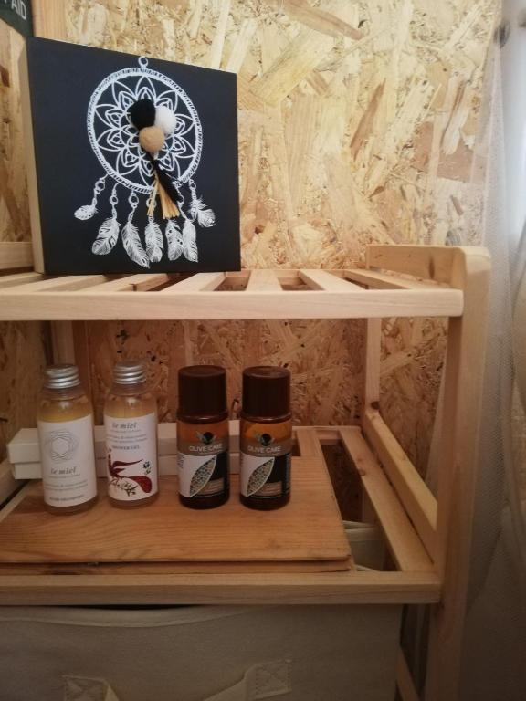 a shelf with four bottles of honey in a closet at Wooden House at the Mountain-private in Paránimfoi