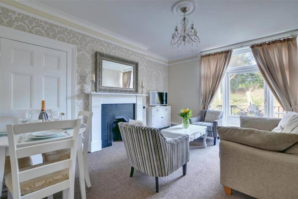 a living room with a couch and a table at Pannett View - in the heart of Whitby in Whitby