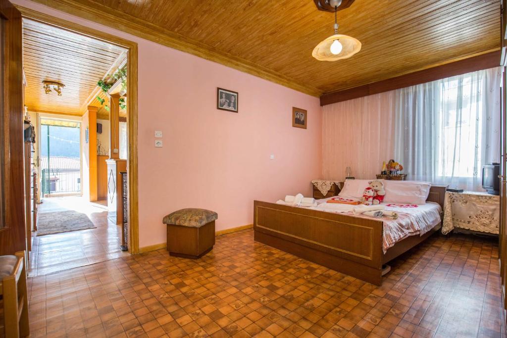 a bedroom with a bed and a large window at Lazaros Maria in Maries