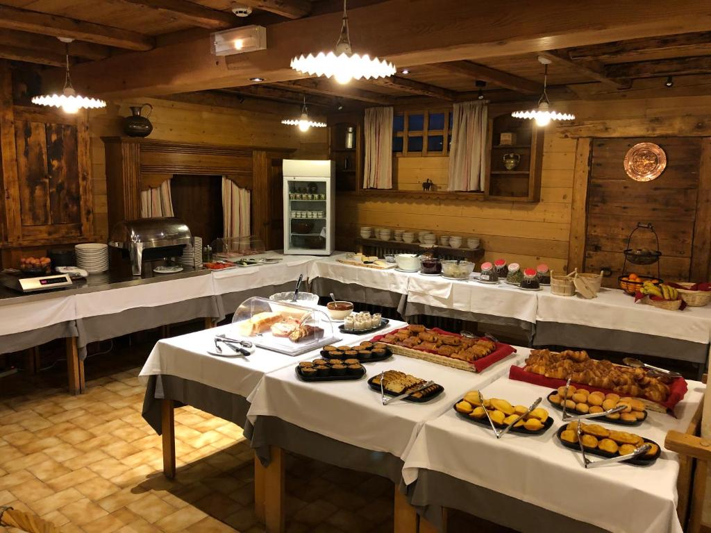 a large room with tables with food on them at Hotel le Petit Dru in Morzine
