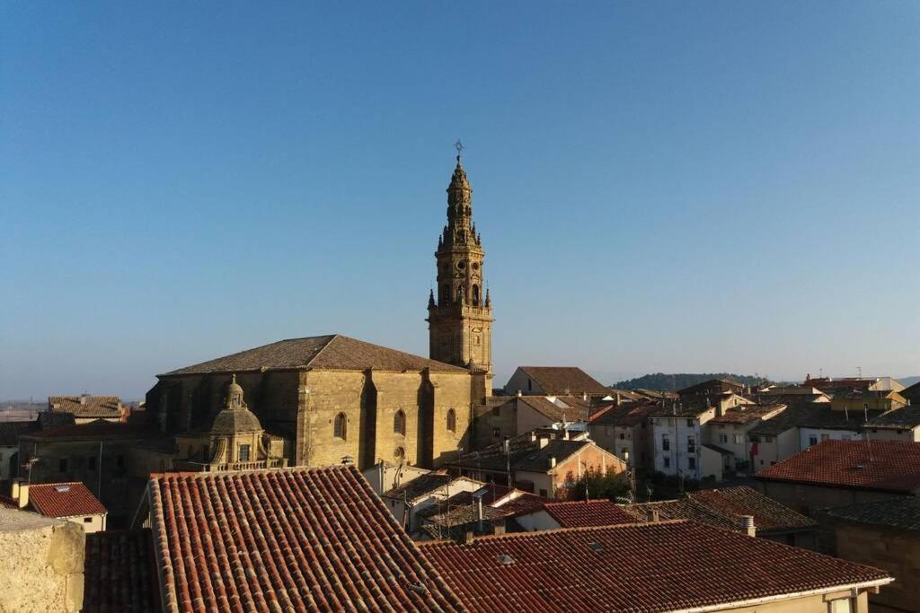 a view of a city with a church and roofs at BONITO ALOJAMIENTO EN BRIONES in Briones