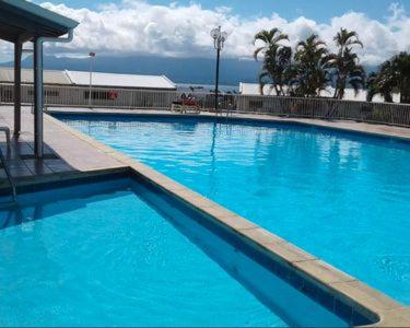 une grande piscine d'eau bleue dans l'établissement STUDIO, PISCINE ET VUE MER A LA MARINA, au Gosier