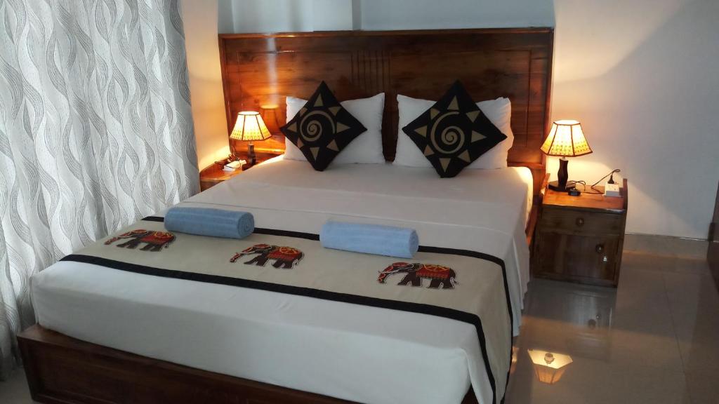 Postel nebo postele na pokoji v ubytování Shani Residence Kandy