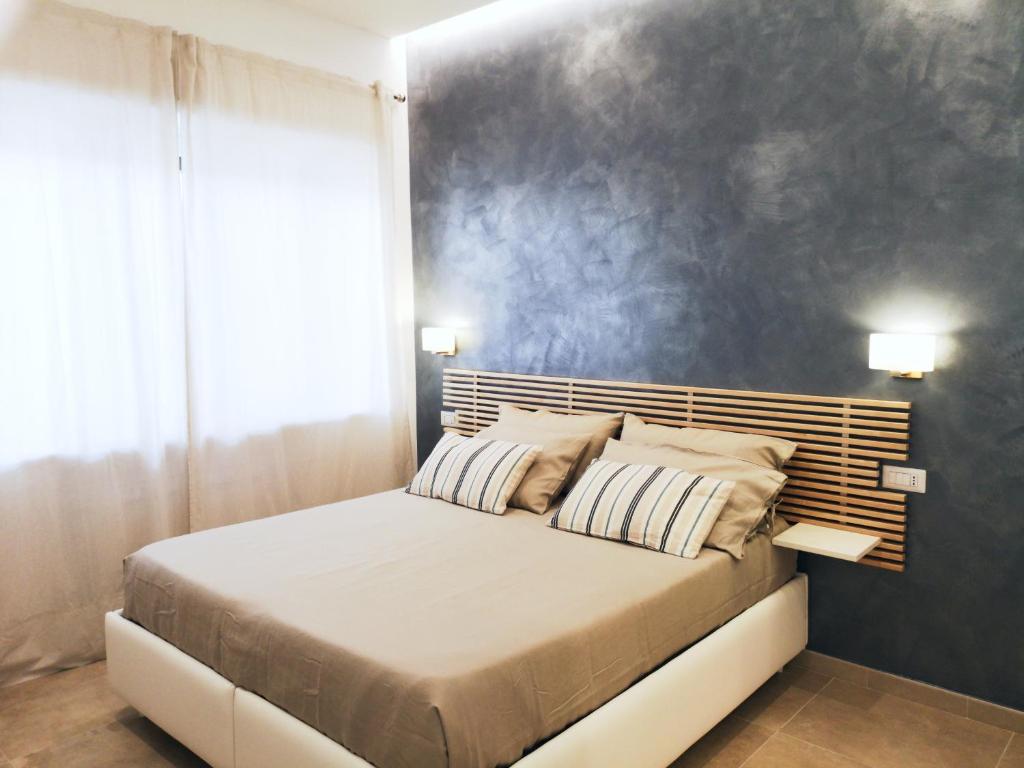 a bedroom with a bed and a blue wall at B&B La Piccola Perla - Sorrento Coast in Sant'Agnello