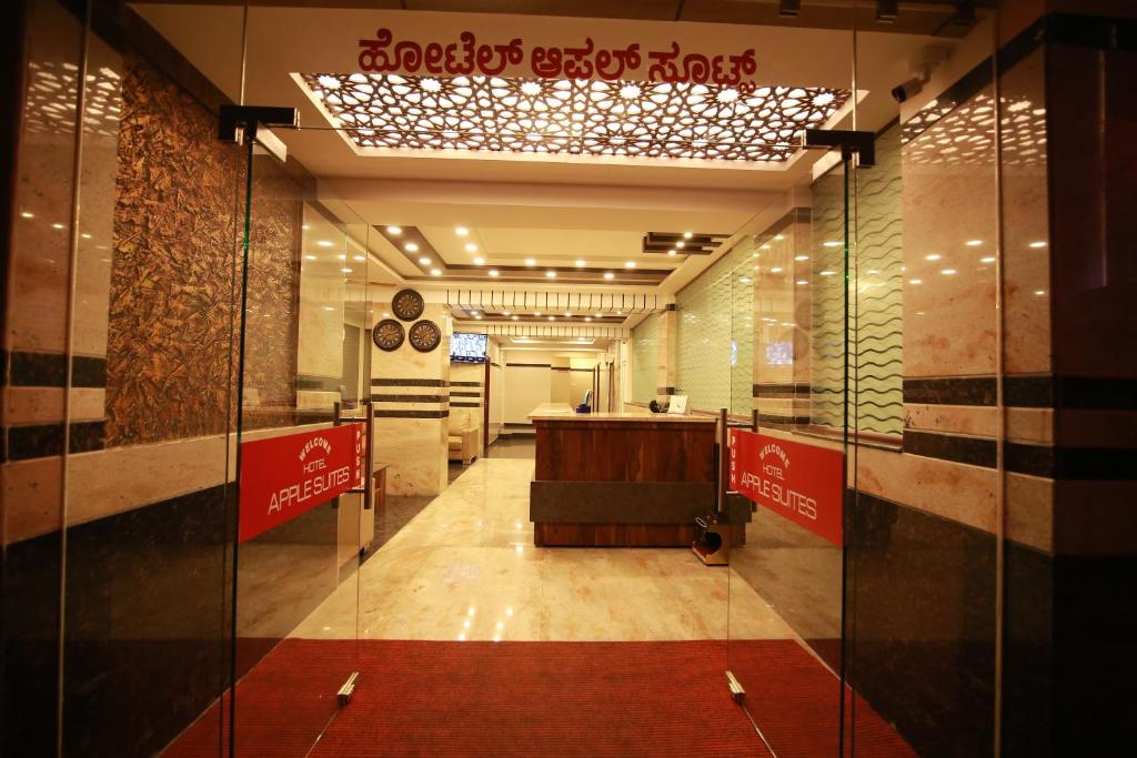 a lobby with a reception desk in a building at Hotel Apple Suites in Bangalore