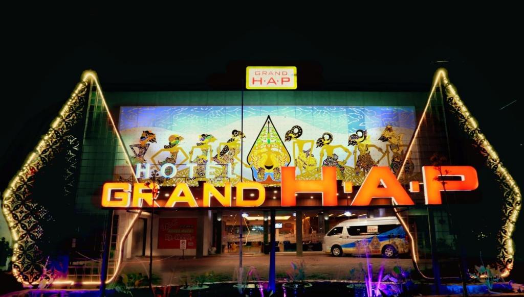 a sign that says go grandah in front of a building at Grand HAP Solo in Solo