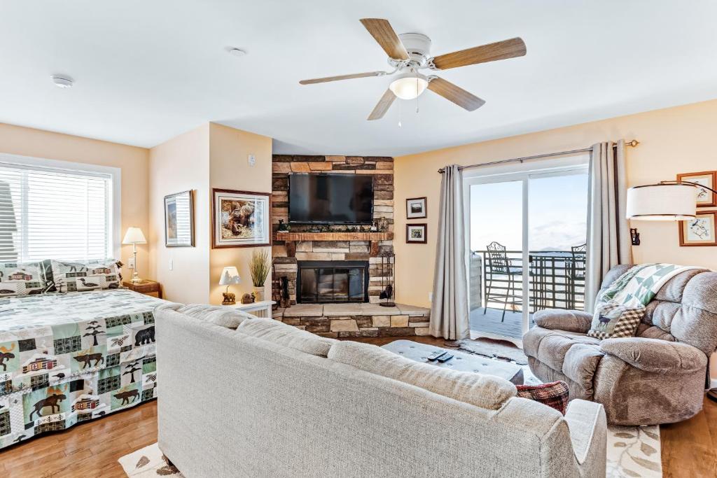 a living room with a couch and a fireplace at Gatlinburg Summit Condo #6208 in Gatlinburg