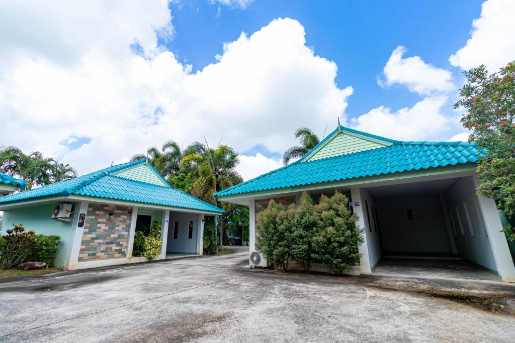 a house with blue roofs and a driveway at Khum Suk Resort in Songkhla