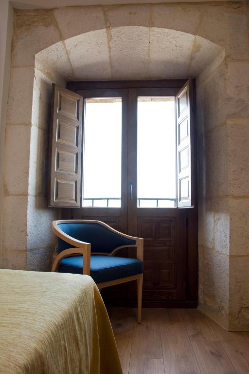 Posteľ alebo postele v izbe v ubytovaní Hospedería Monasterio de La Vid