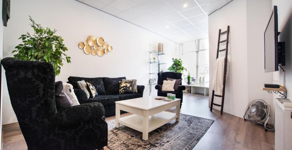 a living room with a couch and a table at Luxurious two bedroom apartment A kwartier Center in Groningen