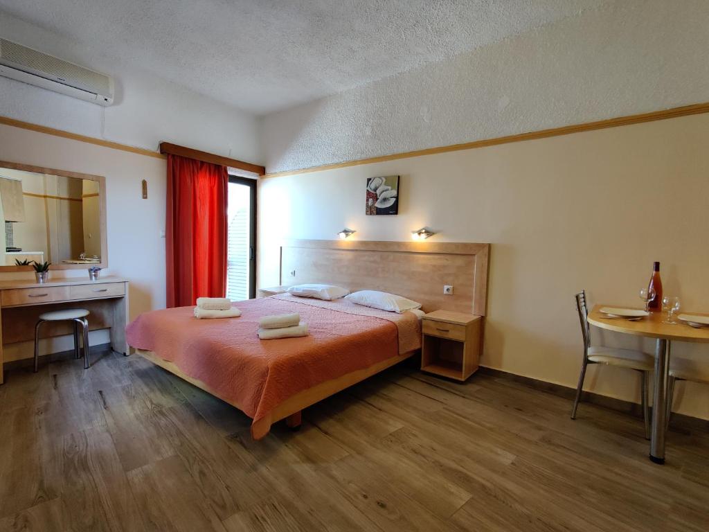 a bedroom with a bed and a desk and a table at Minos Studios in Chania Town