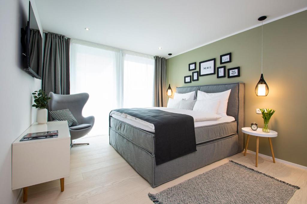 a bedroom with a bed and a desk and a chair at Business Hotel Maier - kontaktloser Check-in in Götzis