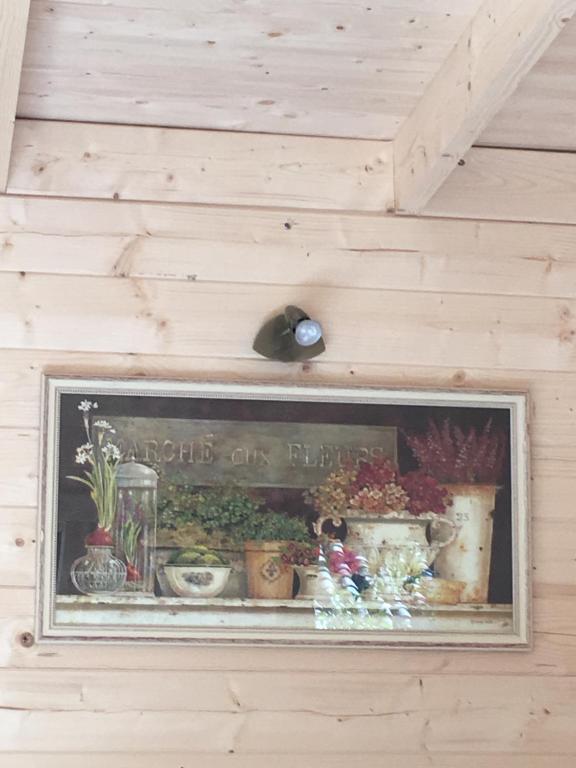 a framed picture of plants on a wall at La cabane des amoureux du jardin in Barjols