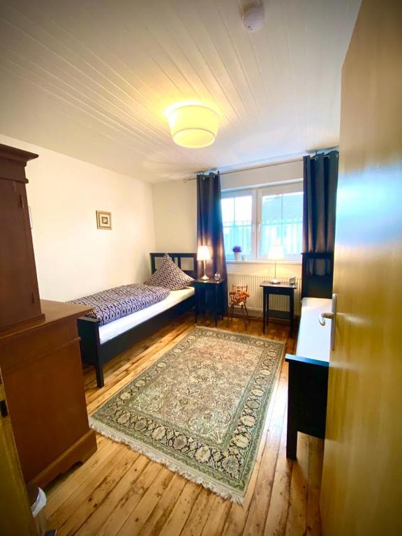 a living room with a bed and a rug at Ferienwohnung in Münchsmünster