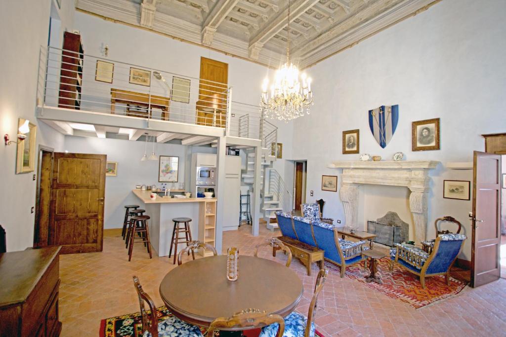 a living room with a table and a fireplace at The Piano Nobile in Montepulciano