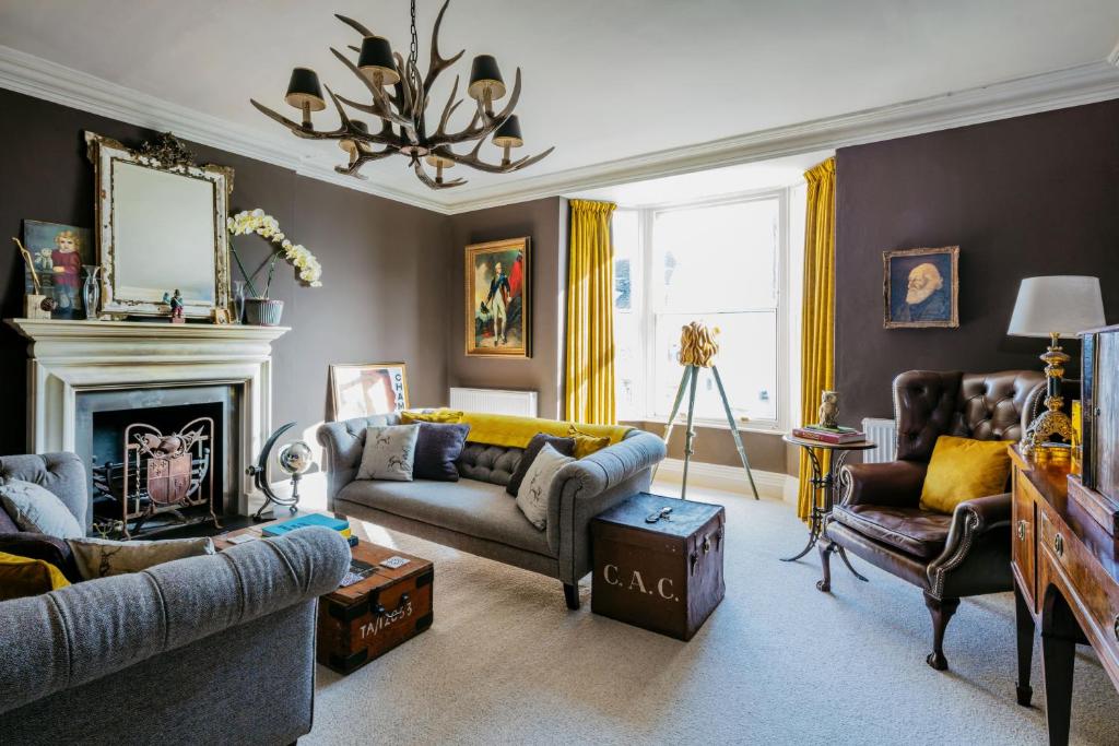 a living room with a couch and a fireplace at The Surveyor's House Tetbury in Tetbury