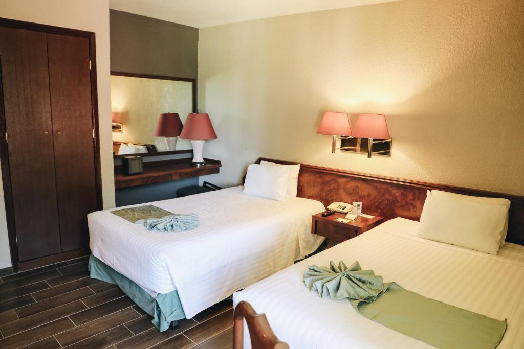 Postel nebo postele na pokoji v ubytování Hotel La Joya Tulancingo