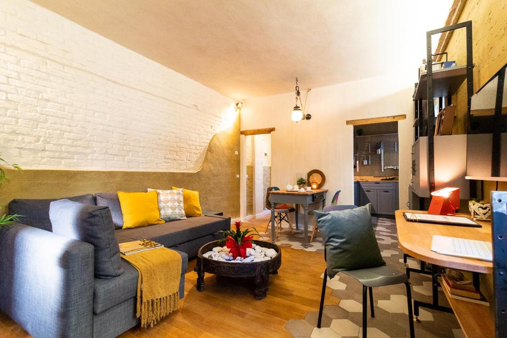 a living room with a blue couch and a table at La casa di Giò - Bio Appartamento in Osimo