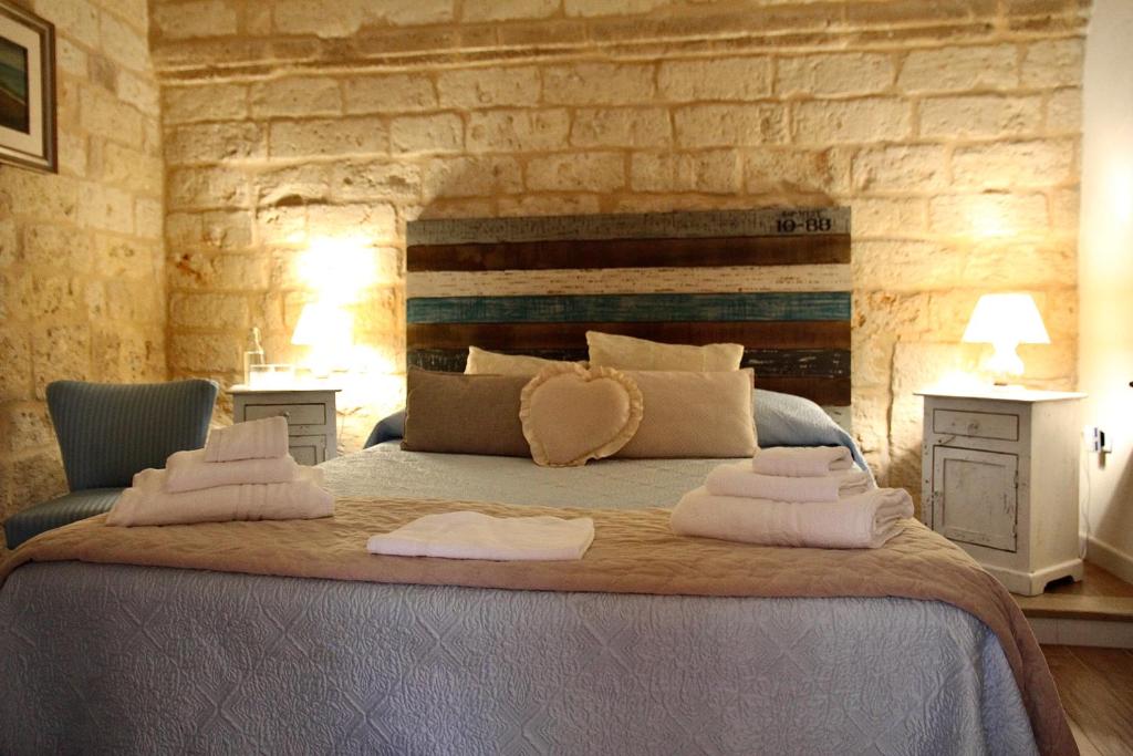 a bedroom with a large bed with two towels on it at La Stanza in Bari