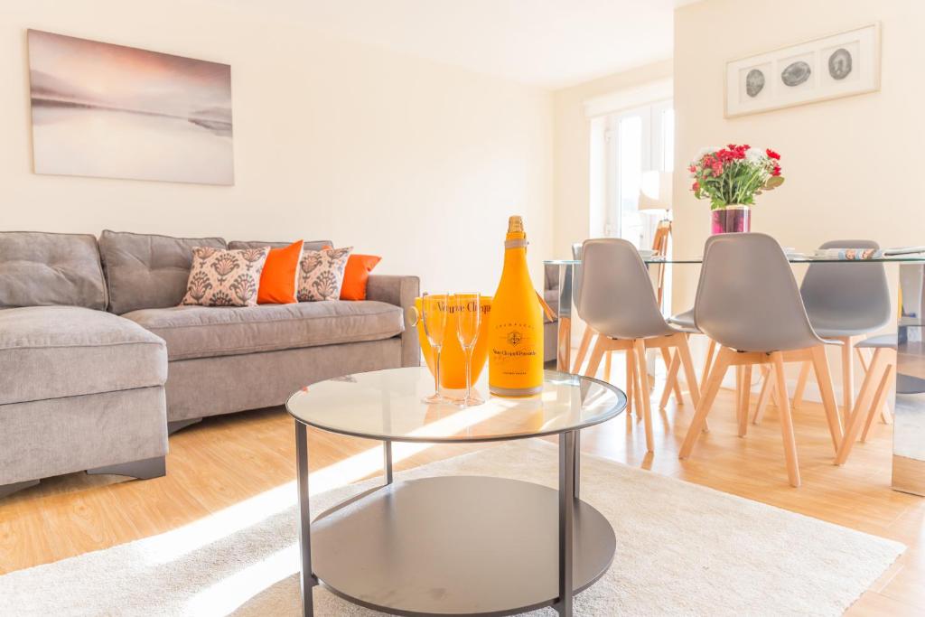 a living room with a table with two bottles on it at Rana Building Marston 1 & 2 Bed Apts close to JR Hospital in Oxford