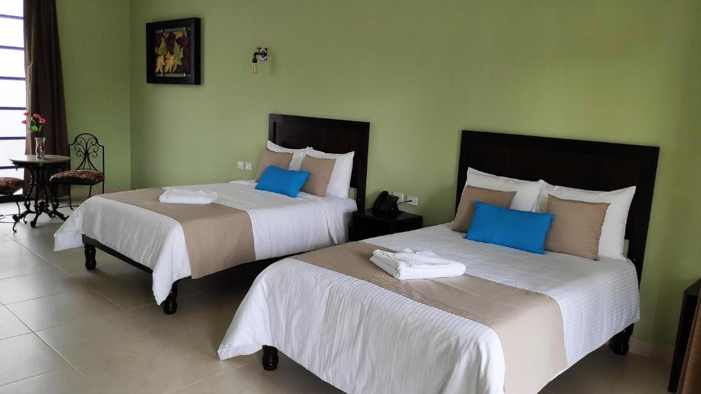 Postel nebo postele na pokoji v ubytování Hotel Los Frailes, Valladolid, Yucatán