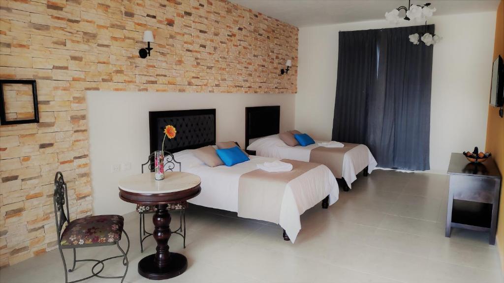 Postel nebo postele na pokoji v ubytování Hotel Los Frailes, Valladolid, Yucatán