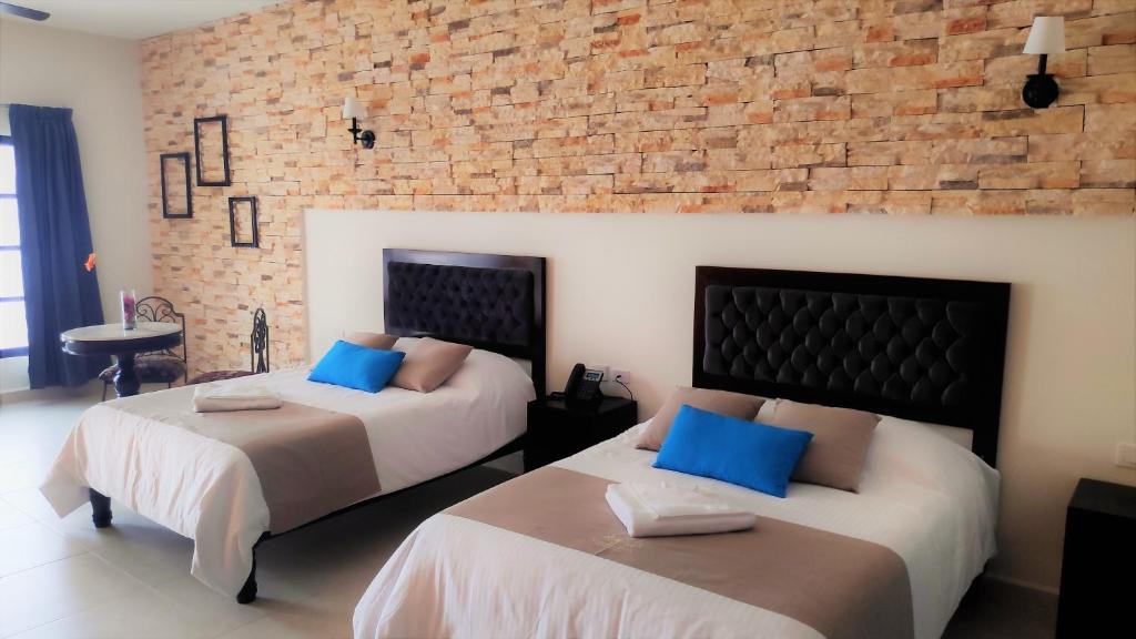 Postel nebo postele na pokoji v ubytování Hotel Los Frailes, Valladolid, Yucatán