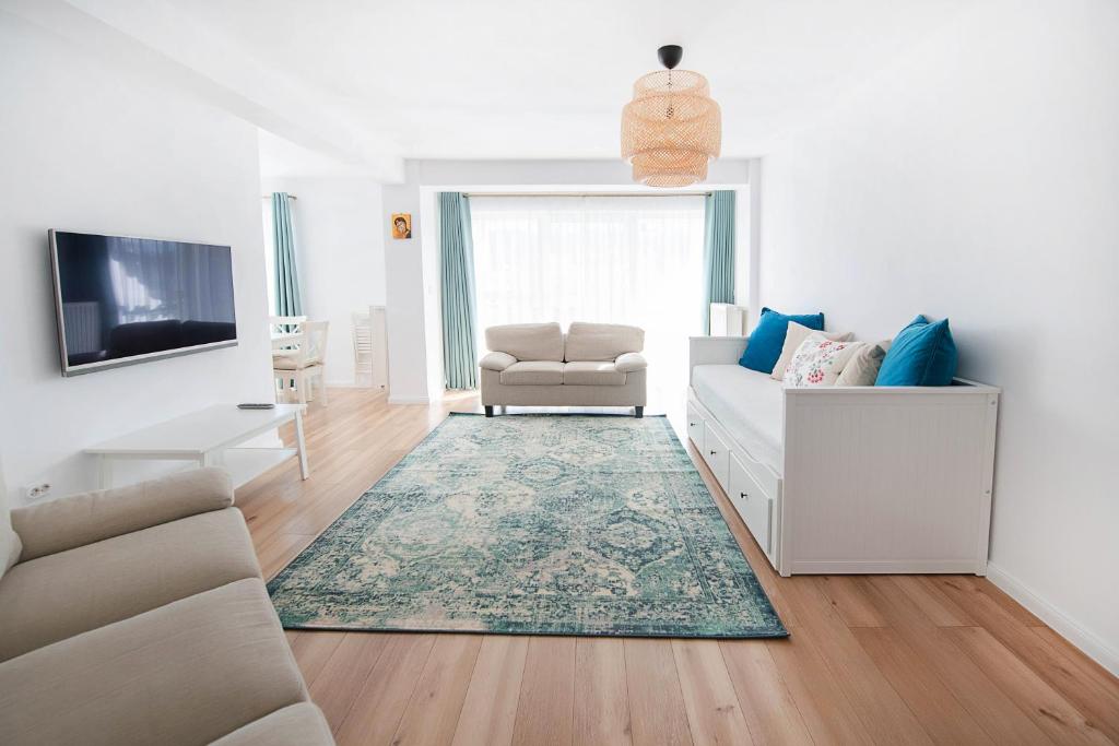 a living room with a couch and a chair at Barko Residence 1 in Braşov