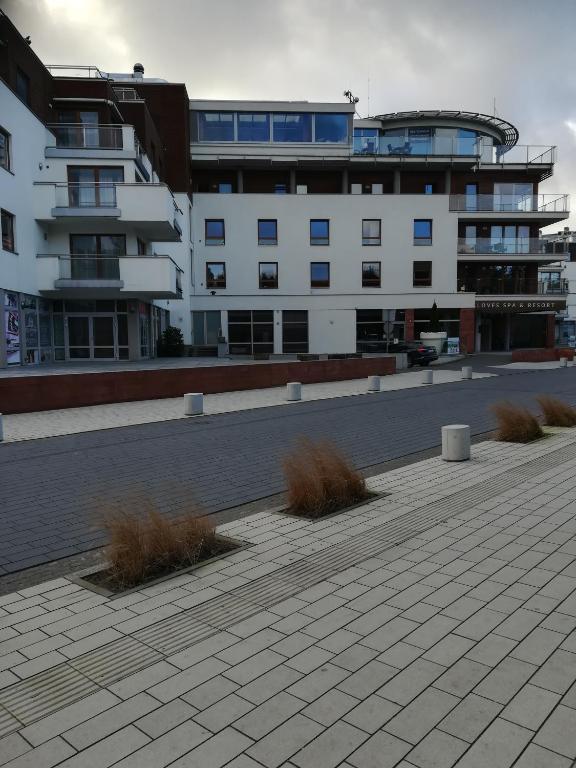 a large white building with plants in front of it at Apartament 50m od plaży z garażem in Władysławowo