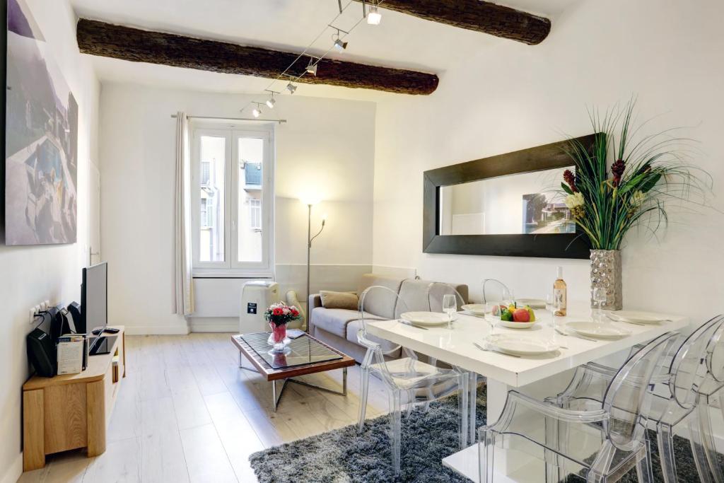 a living room with a table and a couch at LE SAINT JOSEPH - Old tow, 2 appartments in 1 in Nice