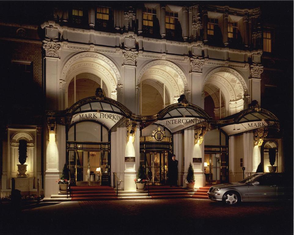 
a car parked in front of a large building at InterContinental Mark Hopkins San Francisco, an IHG Hotel in San Francisco
