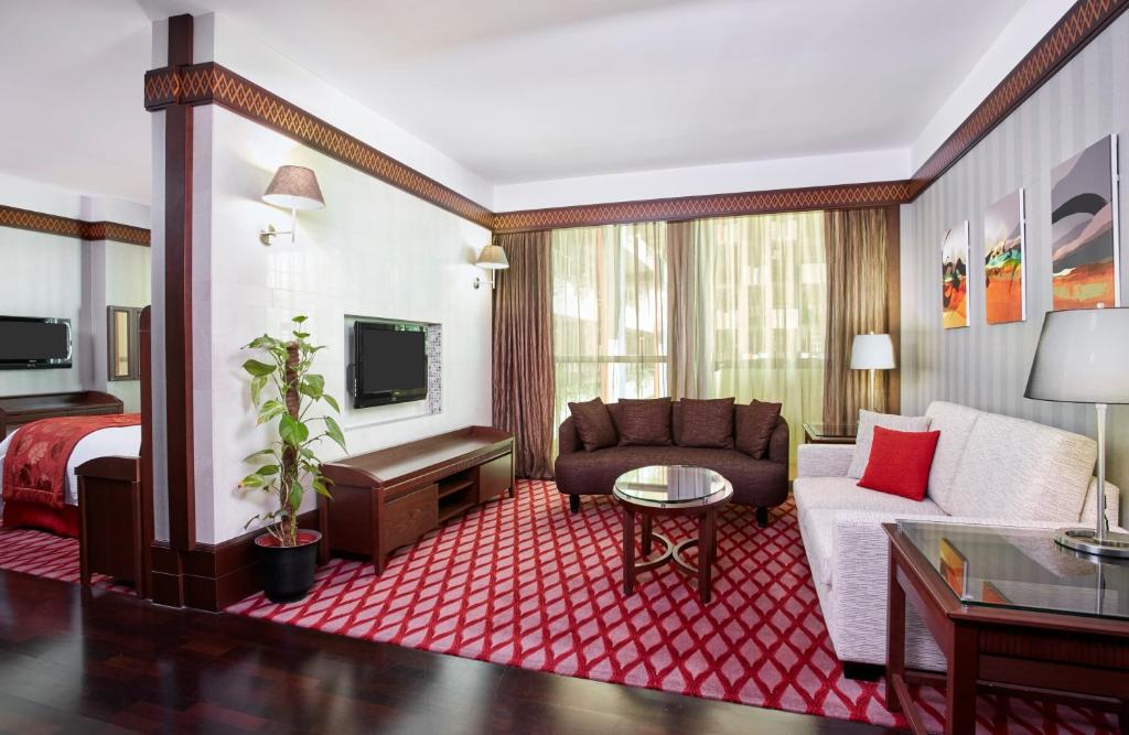 a hotel room with a couch and a bed at Holiday Inn Kuwait Al Thuraya City by IHG in Kuwait