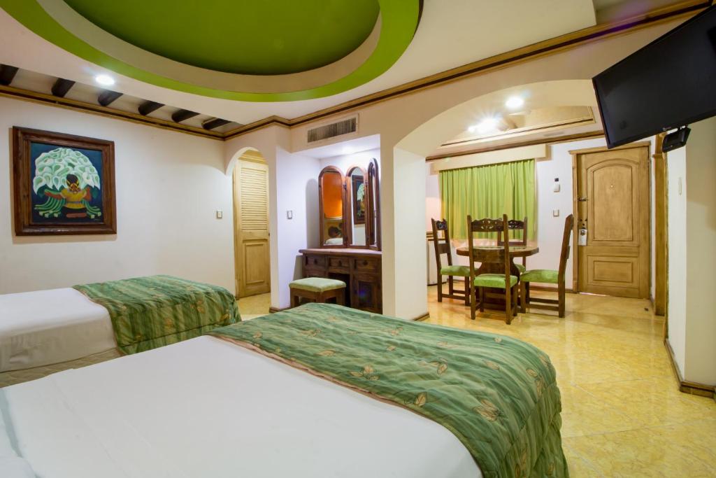 Postel nebo postele na pokoji v ubytování Suites Flamboyanes