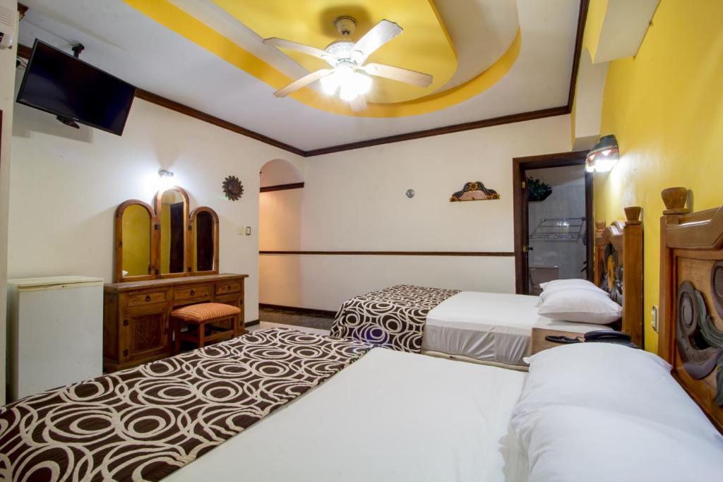 Postel nebo postele na pokoji v ubytování Suites Flamboyanes