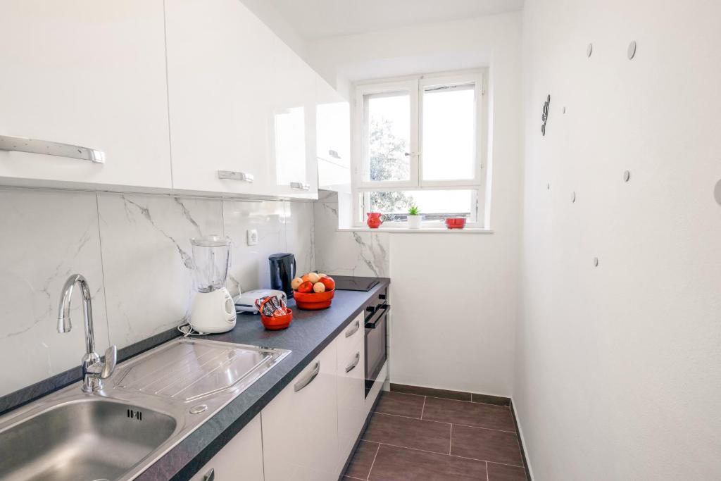 a kitchen with a sink and a counter top at Ana Guesthouse in Dubrovnik