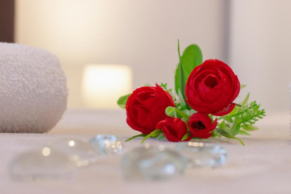 two red roses sitting on top of a table at Ana Guesthouse in Dubrovnik