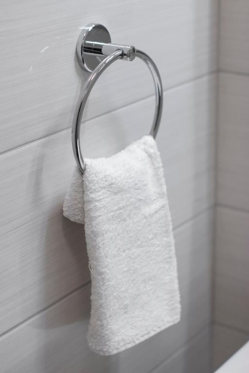 a white towel hanging on a towel rack in a bathroom at Ana Guesthouse in Dubrovnik